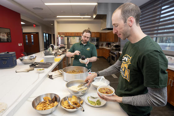 Marcus Brick (left) and Mark Radish prepare a meal for local firefighters. Photo by Evan Cantwell/Creative Services.